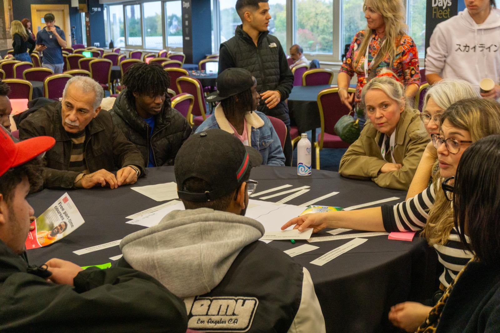 Diverse group of people in a roundtable discussion at a VFCC event